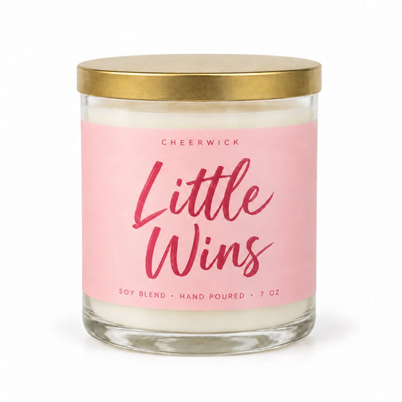 Little Wins candle in a coral pink label